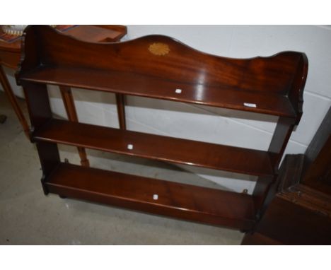 An Edwardian mahogany wall shelf