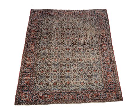 A Tabriz carpet, approximately 343 x 245cmCondition Report: Wear overall. Patches of additional wear reveal underlying weft -