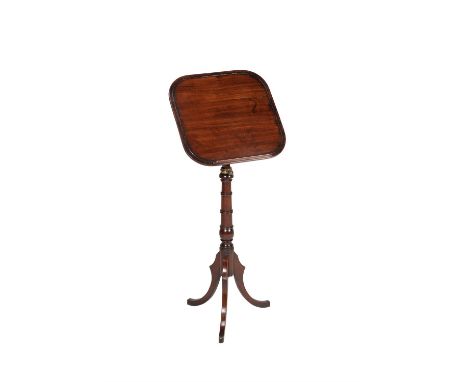 A Regency mahogany reading stand, circa 1815, the adjustable rest too above a ring turned stem and hipped outswept legs, 72cm