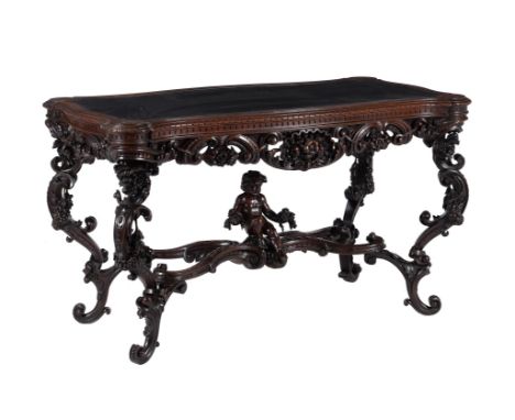 An Italian carved walnut library or centre table, circa 1870, the cartouche shaped top with gadrooned edge and leather inset,