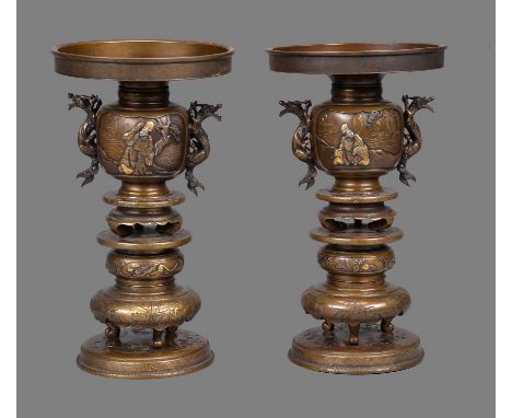A Pair of Japanese Bronze Vases, each of multi-layered form resting on a broad circular base, the upper section (of two)  bea