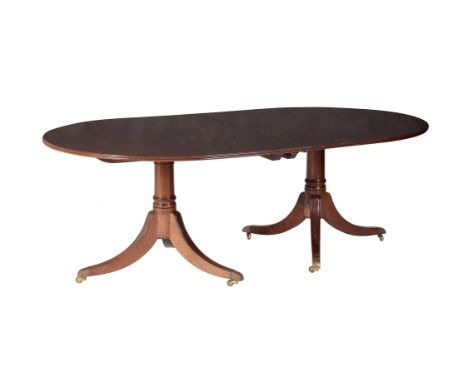 A mahogany twin pedestal dining table, in George III style, second half 20th century, with two additional leaf insertions, 73