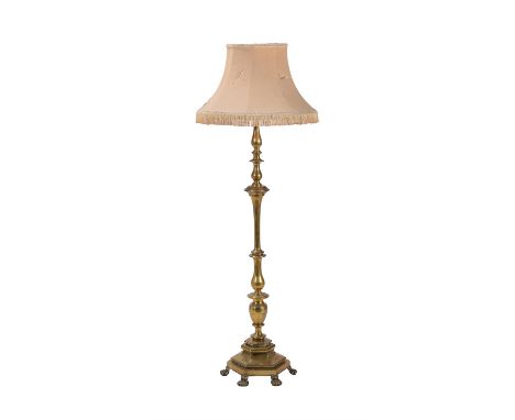 An Edwardian brass standard lamp, early 20th century, the knopped stem descending to a hexagonal base raised on paw feet to t