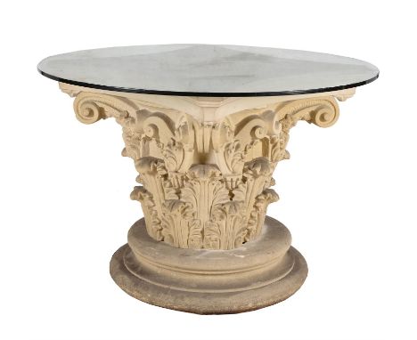 A glass topped and composite stone centre table, 20th century, the circular top above the base modelled as a Corinthian capit