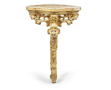 A Continental carved giltwood corner console table, mid 18th century, the shaped quarter circle marble top above a pierced fo