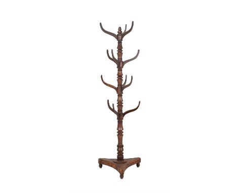 A Victorian mahogany hall stand, circa 1870, with four tiers of bracket supports to the turned stem above the triform base, 1