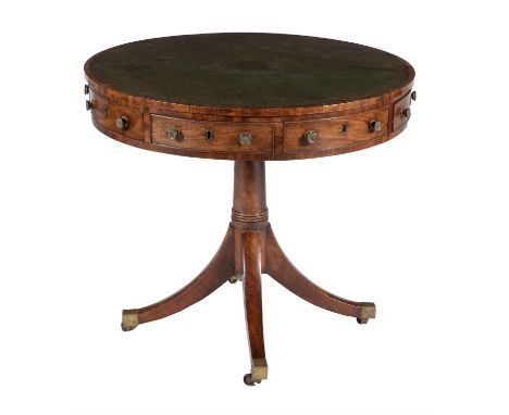 A George III mahogany drum library table, circa 1810, the leather inset top above a frieze with arrangement of four drawers i