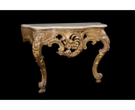 A companion pair of giltwood console tables, second half 19th century, each with a white marble top above the pierced scroll 