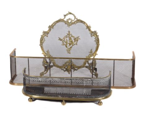 A French gilt metal and mesh firescreen in Rococo Revival style, early 20th century, of cartouche form and cast with rocaille