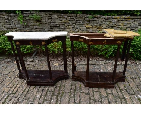A pair of French Empire mahogany console tables with marble tops and classical motif ormolu mounts raised on circular section