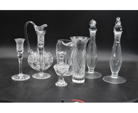 A small signed Lalique jar and stopper along with a pair of cut crystal candlesticks, a pair of slender decanters and stopper