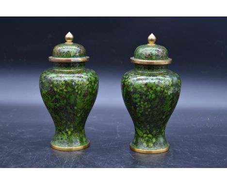 A pair of Chinese cloisonné lidded vases with all over floral enamel decoration. H.23cm 