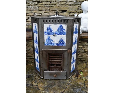 A late 19th century Dutch steel free standing fireplace with inset blue and white sailboat tiles  with removeable grate and f