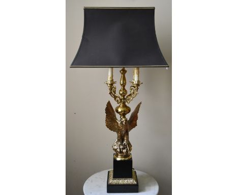 A heavy brass four branch table candelabra lamp in the shape of a spread winged eagle on a classical style base. H.90cm W.20c
