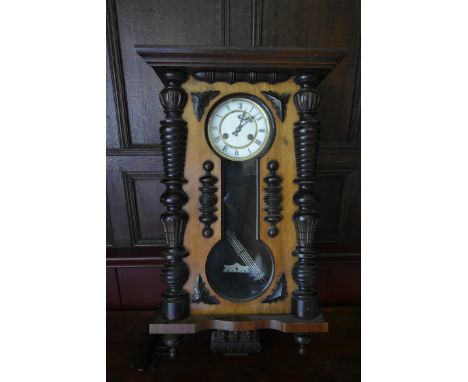 A 19th century walnut cased Vienna regulator, white enamel dial with Roman numerals flanked by turned pilasters.  H.70 W.42 D
