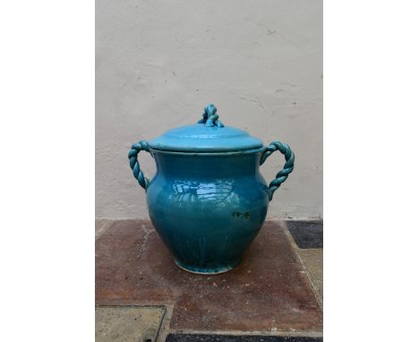 An Eastern turquoise glazed lidded storage pot with twin rope design handles and finial. H.45 Dia.40cm 