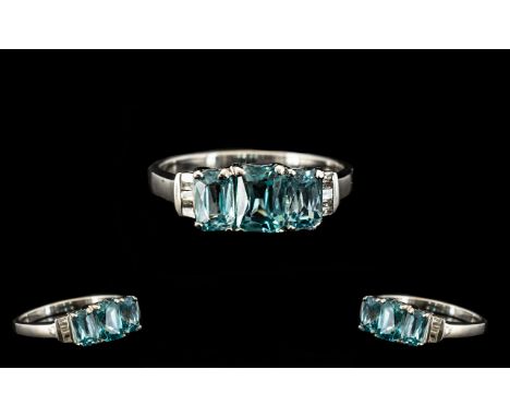 Natural Blue Zircon and Diamond Ring, three octagon cut blue zircons, the central stone slightly larger than those to either 