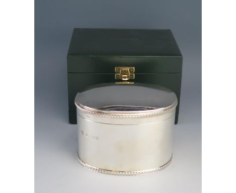 An Elizabeth II silver oval tea caddy, maker Barker Ellis Silver Co, Birmingham, 1997,  the hinged lid with gadrooned borders