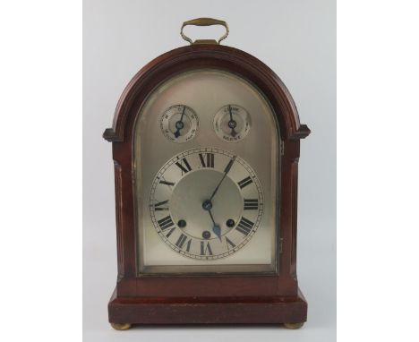 A mahogany cased director's style bracket clock, with arched silvered Roman dial with regulation and Chime/Silent to the arch