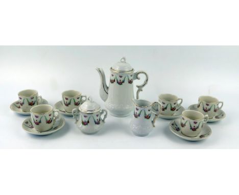 A late 19th /early 20th century continental nursery tea service, with floral garland decoration, includes teapot, sugar basin
