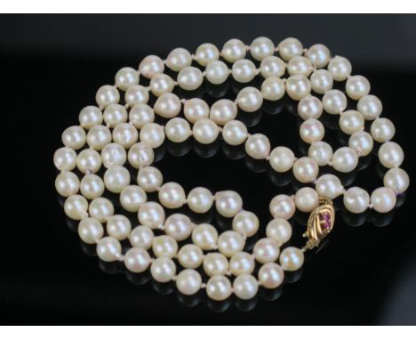 A 29.5" Matched untested Pearl Necklace with a 9ct gold double sided clasp set with two rubies or spinels to each side, pearl