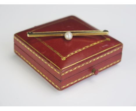 A 9ct Gold and untested Pearl Bar Brooch, full hallmarks, 57mm, 3.5g and presented in a Goldsmiths &amp; Silversmiths box 