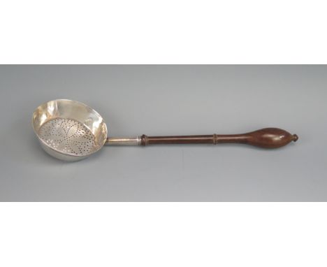 A 19th century silver straining ladle, indistinct mark, with pierced circular bowl on a turned fruitwood handle, 23.5cm long.