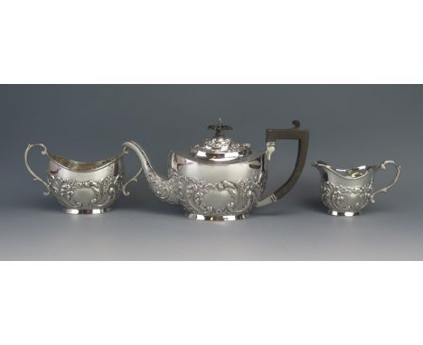 An Edward VII silver three-piece oval tea set, maker T E Beardsmore, Birmingham, 1908/09, with repoussÃ© scroll and foliate d