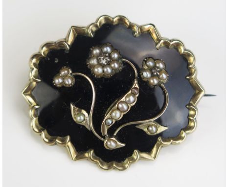 A Victorian Black Enamel Mourning Brooch decorated with two untested pearl set flowers with rose cut diamonds and in an unmar