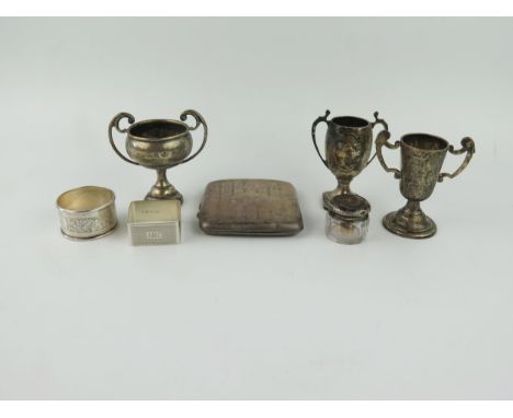A mixed collection of silver, various makers and dates, includes, miniature trophy cups, napkin rings, rouge pot, locket and 