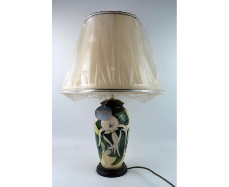 A Moorcroft pottery table lamp, "Sesquipedale" pattern of ovoid form , by Emma Bosson, 30cm high excludes fittings and shade.