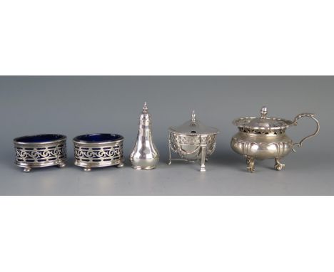 A pair of George V silver oval salts, with blue glass liners, two silver mustard pots, and a silver pepperette, total weight 