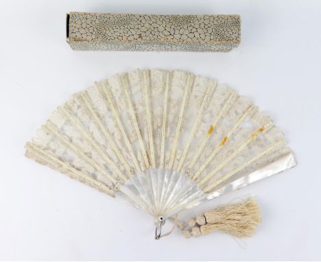 An Edwardian fan with lace work leaf mounted on mother-of-pearl sticks and guards, 19cm long. 