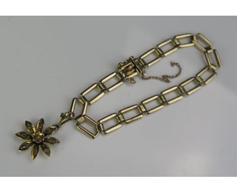 A 9ct Gold Bracelet with 9ct gold untested pearl set flower head pendant, 6.5" (17cm), 10.1g