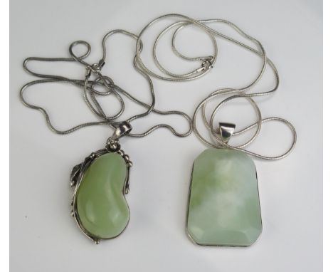 A Silver and Jade Pendant in a foliate setting and on chain (65mm drop) and one other silver pendant on chain 