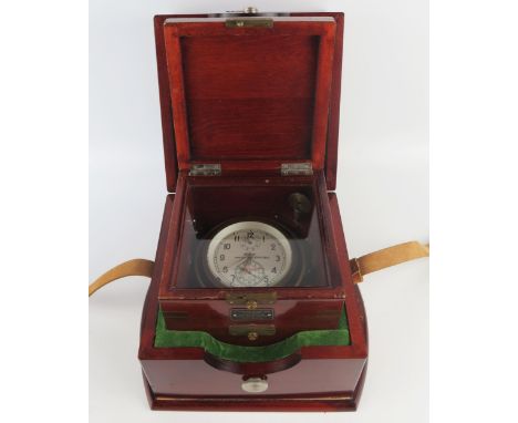 A Russian lacquered brass ships chronometer, with 9.5cm Arabic dial with subsidiary seconds dial and state of winding dial, o