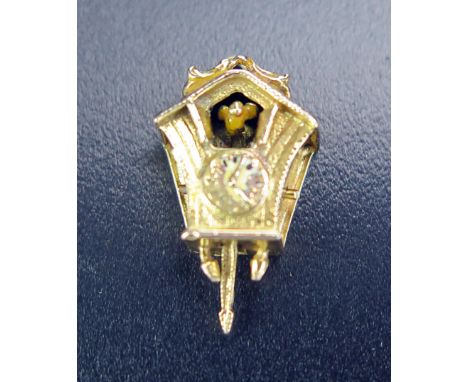 A Hallmarked 9ct Gold Charm Cuckoo Clock with articulated bird moved by the pendulum, 2g 