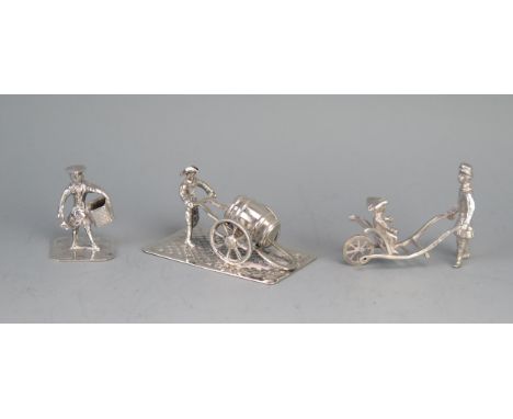 A miniature model of a street vendor with barrel cart, a figure with a child in a barrow and a single street vendor, total we
