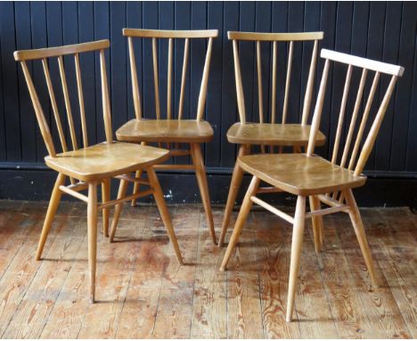 A set of four 1950's Ercol blonde stick-back chairs, with solid seats and turned legs. 