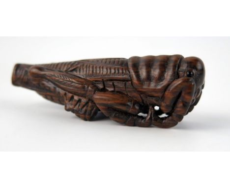A Japanese carved boxwood netsuke in the form of a locust,  signed, 7cm long. 