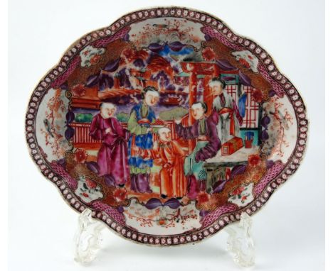 A 19th century Chinese dish of cartouche-shaped outline, decorated in enamels with figures in a garden landscape, 21cm wide, 