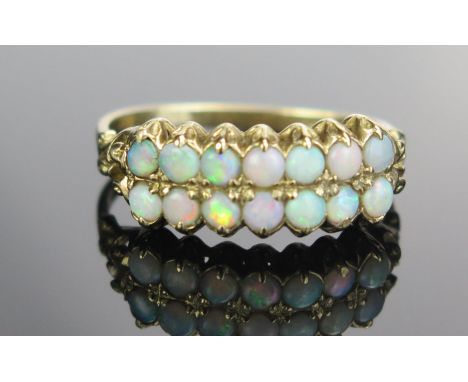 A 9ct Gold and Opal Two Row Ring, London hallmarks, size O.5, 2g 