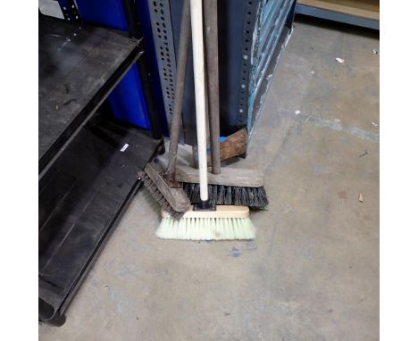 Collection of various sized yard brushes and a felling axe. Not available for in-house P&amp;P 