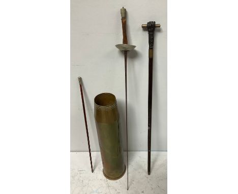 A large 4.5 Mk2 Naval Artillery shell brass casing dated 1957, 64cm high, together with a walking stick with metal fist holdi