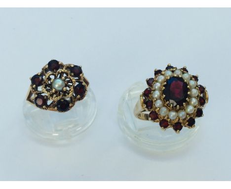 A 9ct gold garnet and seed pearl cluster dress ring, set with an oval garnet to the centre with 14 x pearls and 14 x garnets 