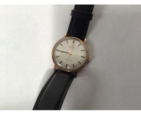A gents 9ct gold cased Omega Geneve manual wind wristwatch, the silvered dial with applied gilt batons denoting hours, inscri