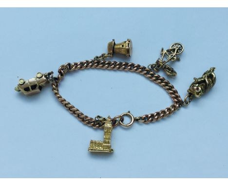 A 9ct gold multi charm bracelet, including car, koala bear, windmill and church, weighing 33.7 grams. 