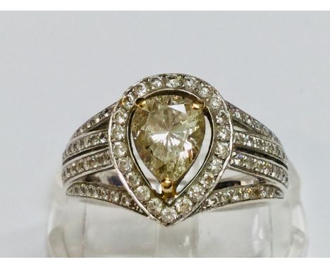 A ladies 18ct white gold diamond ring, set with a pear shaped diamond to the centre in a claw setting with a yellow gold fill