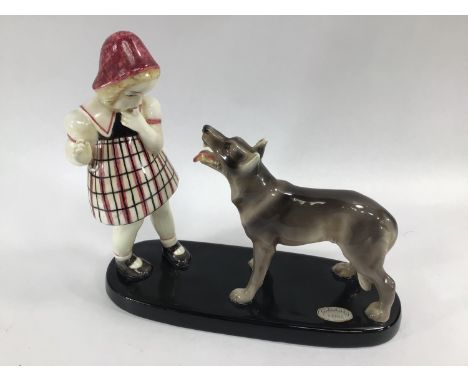 A Goldscheider pottery figure-group of a girl and a dog, raised on plinth base, impressed marks '7027/338/16' to base, 22cm (
