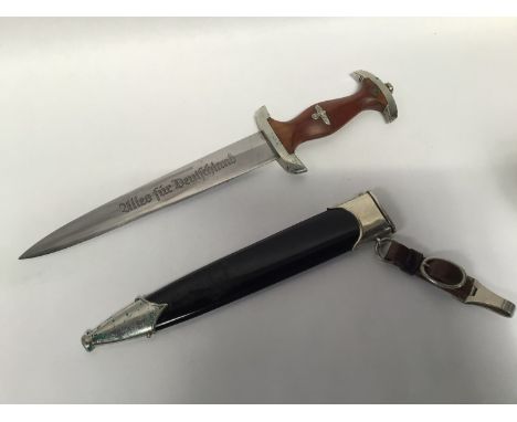 A WWII German Third Reich SA dagger and scabbard, the double edged blade engraved with makers mark 'Solingen' and etched 'All